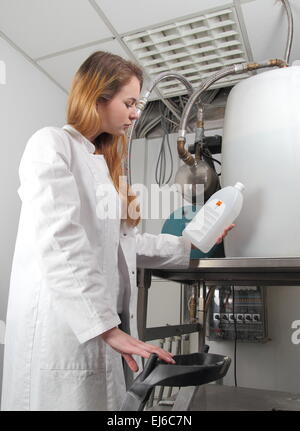 A Woman at a  plant with chemicals Stock Photo