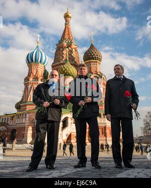 International Space Station Expedition 43 crew members Cosmonauts Gennady Padalka and Mikhail Kornienko of the Russian Federal Space Agency and Commander Scott Kelly of NASA pose for a photograph in front of St. Basil's Cathedral as part of traditional pre-launch ceremonies March 6, 2015 in Moscow, Russia. The trio will launch from the Baikonur Cosmodrome in March 28 for a one-year mission aboard the station. Stock Photo