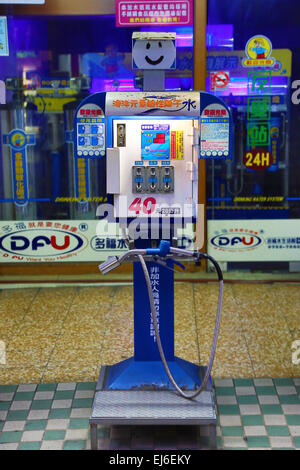 Funny petrol pumps with faces at a petrol station in the street in Tainan, Taiwan Stock Photo