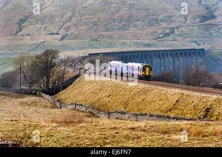 A Sprinter passenger train from Carlisle heads south to Leeds after crossing the Ribblehead viaduct, North Yorkshire, UK