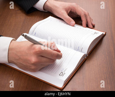 The man in the suit writes in the weekly Stock Photo
