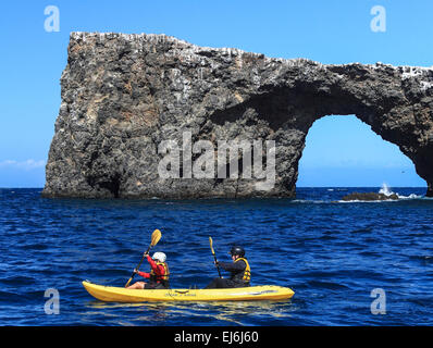 Kayakers paddle beyond Arch Rock at Channel Islands National Park Stock Photo