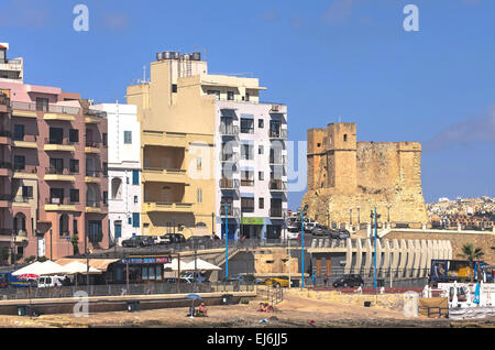 Malta, St Paul’s Bay: Waterfront of the old fishing village San Pawl il-Bahar with the Wignacourt Tower, the oldest coastal defence post in Malta. Stock Photo