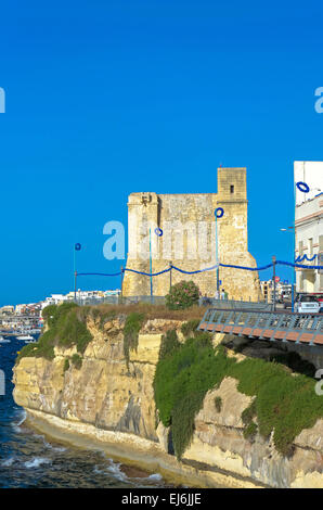 Malta, St Paul’s Bay: Waterfront of the old fishing village San Pawl il-Bahar with the Wignacourt Tower, the oldest coastal defence post in Malta. Stock Photo
