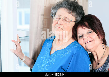 A senior grandmother with is daughter having great time in room Stock Photo