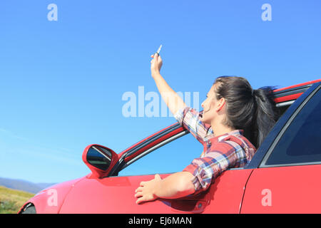 A beautiful woman sitting in her new car, holding the keys. Stock Photo