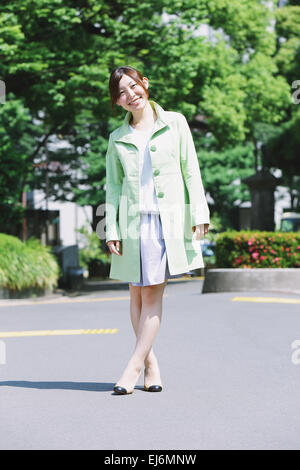 Young smiling Japanese woman in a park Stock Photo