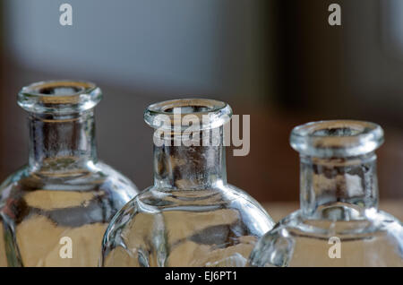 three empty clear glass bottles a row Stock Photo