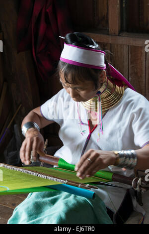 Padaung (Kayan Lahwi) woman wearing brass neck coils weaving, Inle Lake, Shan State, Myanmar Stock Photo