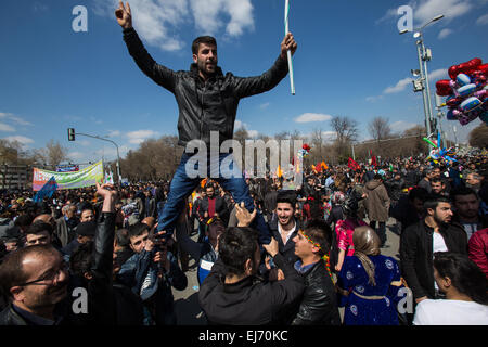 Turkey. 22nd Mar, 2015. A man stands on his friends shoulders, holding a banner and making the “Victory” sign, at Newroz celebration rally. © Piero Castellano/Pacific Press/Alamy Live News Stock Photo