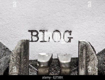 Typewriter with white paper page on wooden table. sample text Blog. Stock Photo