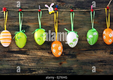 Colorful Easter eggs on a fun clothespins. Stock Photo
