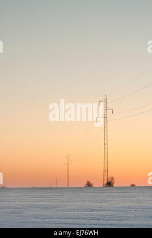 High-voltage pylons in winter Stock Photo - Alamy