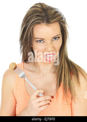 Attractive Young Woman Holding a Pickled Onion on a Fork Stock Photo