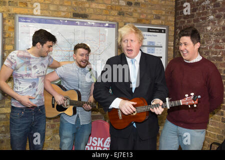 London, UK. 23 March 2015. L-R: Matt Pickersgill, Aaron Murphy, Boris Johnson and Jack Frimston. The Mayor of London Boris Johnson joined London band The Tailormade to officially launch this year's Gigs busking competition and two brand new initiatives aimed at supporting and promoting busking and street performance in the capital and beyond. They include Busk in London, which the Mayor has set up with a range of partners to make busking easier across the capital and a Busking Code of Conduct was unveiled. Stock Photo