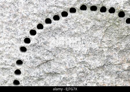 drilled many holes in the granite Stock Photo