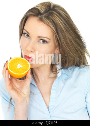 Attractive Young Woman Holding an Orange Stock Photo