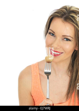 Attractive Young Woman Holding a Pickled Onion on a Fork Stock Photo