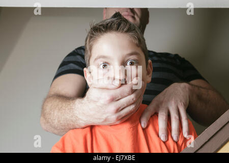 father abused his young boy at home Stock Photo