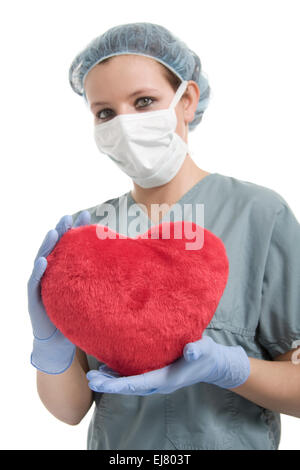 A surgeons , woman wearing protective uniforms,caps and masks an Stock Photo