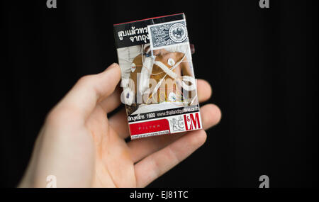 A deterring image of a patient connected to medical mashines features  on a package of cigarettes of the brand L&M from Thailand in Berlin, Germany,  6 March 2015. Photo:  Lukas Schulze/dpa Stock Photo