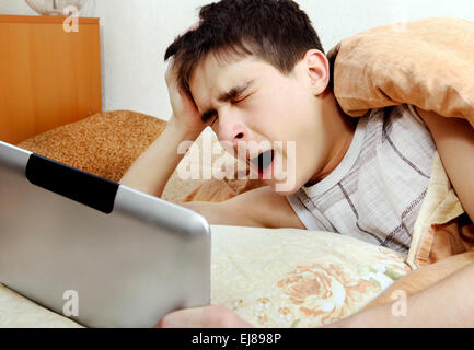 Tired Teenager with Tablet Computer Stock Photo