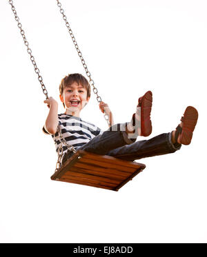 Cute boy playing on swing, having fun. On a white background. Stock Photo