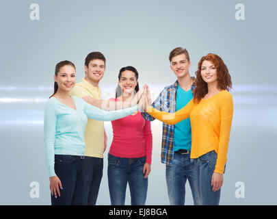 smiling teenagers making high five Stock Photo