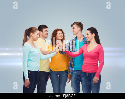 smiling teenagers making high five Stock Photo