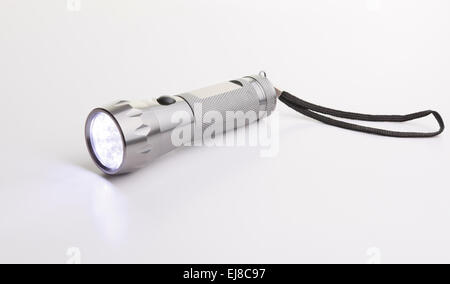 gray flashlight over a gray background on the floor Stock Photo