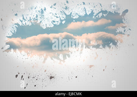 Splash on wall revealing blue sky Stock Photo