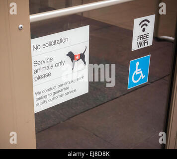 A sign on the door of a store in New York allows the admittance of service animals only, no solicitors and advises potential job applicants that the store drug tests, seen on Saturday, March 21, 2015.  (© Richard B. Levine) Stock Photo