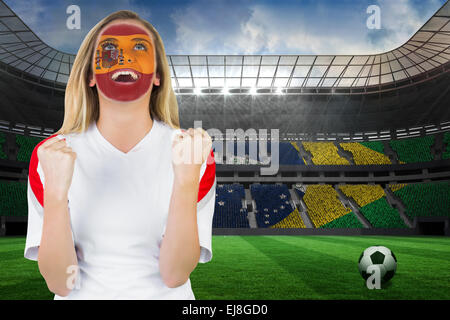 Excited spain fan in face paint cheering Stock Photo