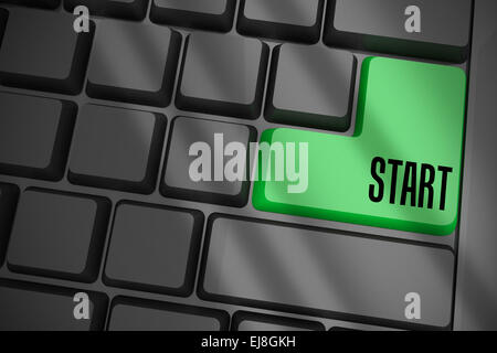 Start on black keyboard with green key Stock Photo