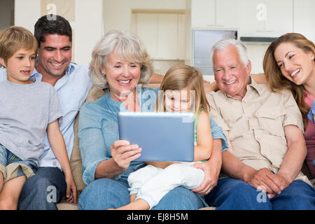 Multigeneration family using digital tablet Stock Photo
