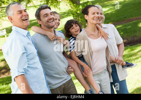 Cheerful extended family standing at park Stock Photo