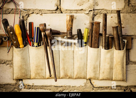 Tools renovation on grunge old brick wall Stock Photo