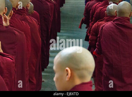 Monks waiting in line at Mahagandayon Monastery, Amarapura, Manadalay, Myanmar Stock Photo