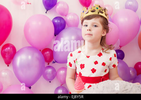 Portrait of funny girl posing in toy crown Stock Photo