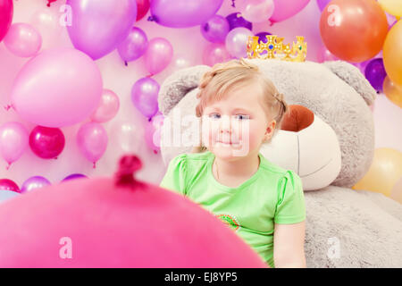 Amusing blonde girl posing in playroom Stock Photo