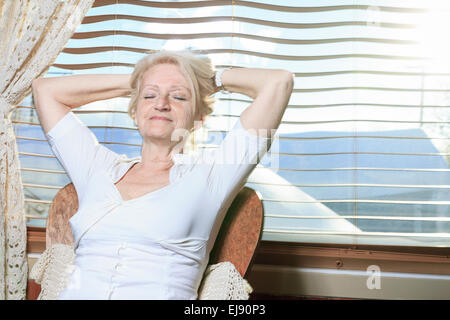 senior woman relaxing on the kitchen Stock Photo