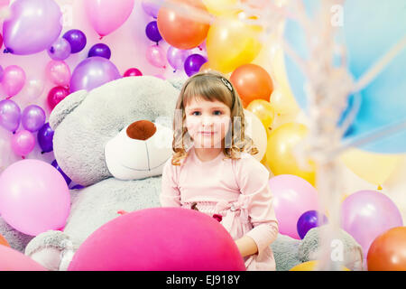 Smiling little girl posing in playroom Stock Photo