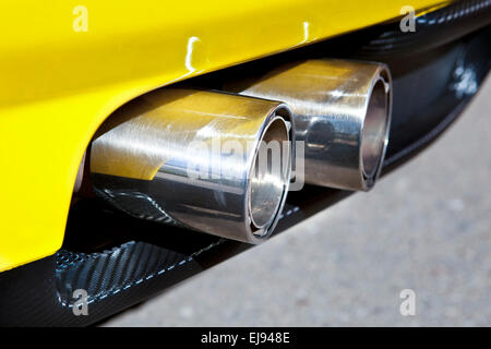 Sports car exhaust pipe with two chromed tubes. Selective focus Stock Photo