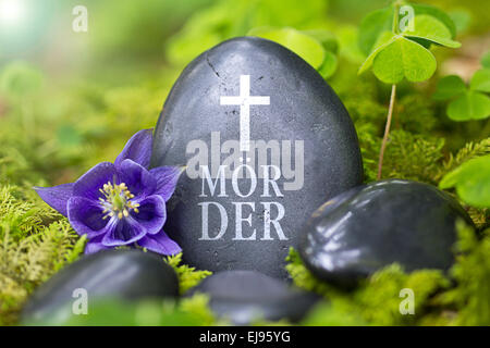 Black stone with the Word „Mörder“ Stock Photo