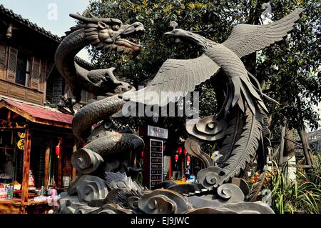 Jie Zi Ancient Town, China:  An imposing sculpture of a mythical Dragon and a Phoenix on Chaoyang Street  * Stock Photo