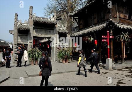 Jie Zi Ancient Town, China:  Ornate carved stone ceremonial entry gate leads into historic Gingko Square Stock Photo