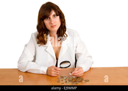 hand hold magnifying glass and coins Stock Photo