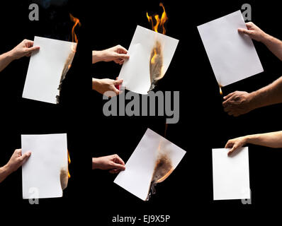 Man hand holding lighter and white burning papers with space for text Stock Photo