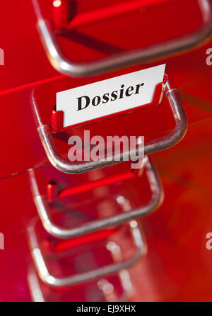 Red file cabinet with card Dossier Stock Photo