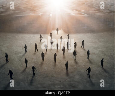 Tiny people walking out of a mysterious maze Stock Photo